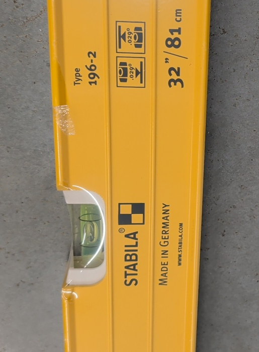 Close-up of the Stabila Type 196-2 spirit level showing the vial housings, center horizontal vial window, and the yellow aluminum frame with structural ridges.