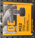 BE Power Equipment M22 female to 3/8 inch FNPT adapter in its yellow and black retail packaging.