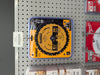A DEWALT 8-1/4 inch, 24-tooth circular saw blade in its retail blister packaging on a store pegboard display.